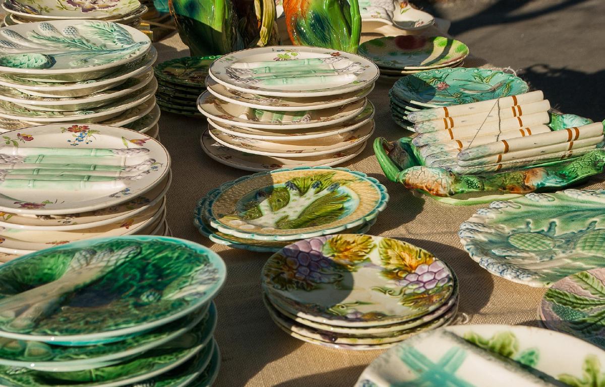 A table of plates laid out for a cleanout sale